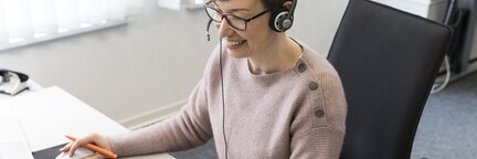 Eine Frau sitzt am Schreibtisch in einem Büro und arbeitet am Computer. | © Die Bremer Stadtreinigung